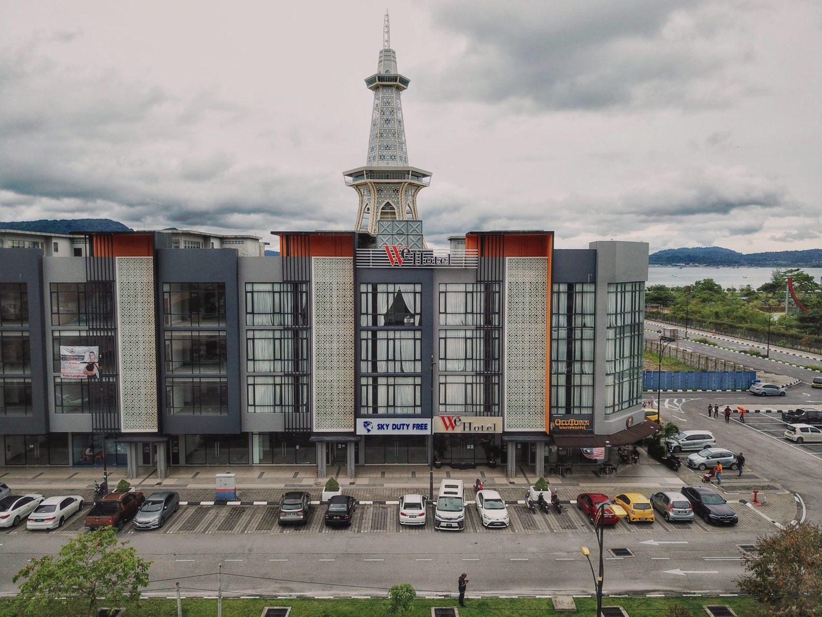 WE Hotel building with Mahatower rising behind it